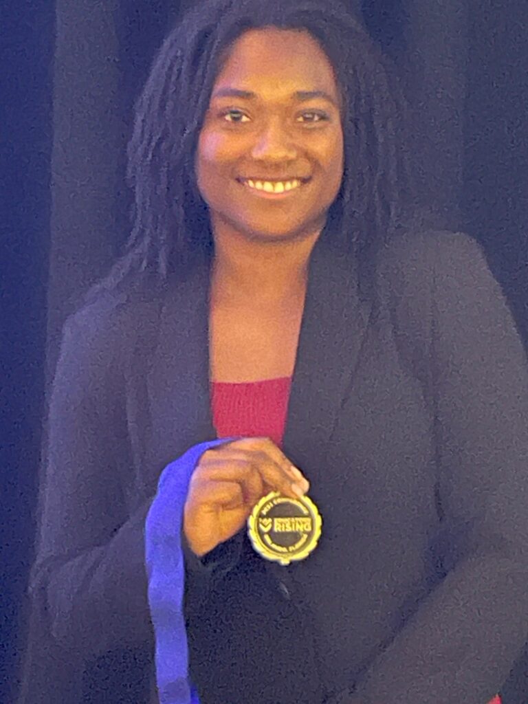 Incoming Educators Rising Kentucky President Janae Allen showing off her Grand Champion medal for Lesson Plan and Development-Humanities