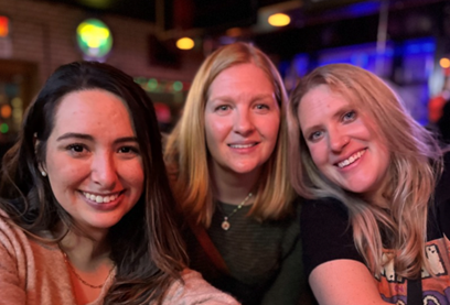 Ashley K. Smith and colleagues huddled together at a staff holiday party