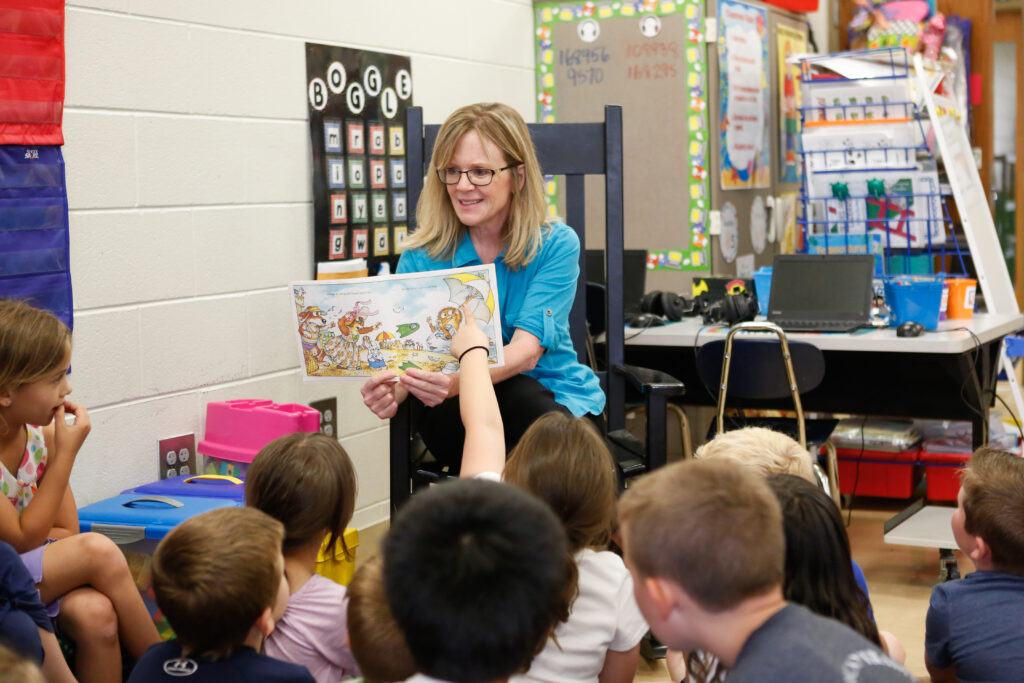 A teacher at Pine Grove Elementary reads a book to students.