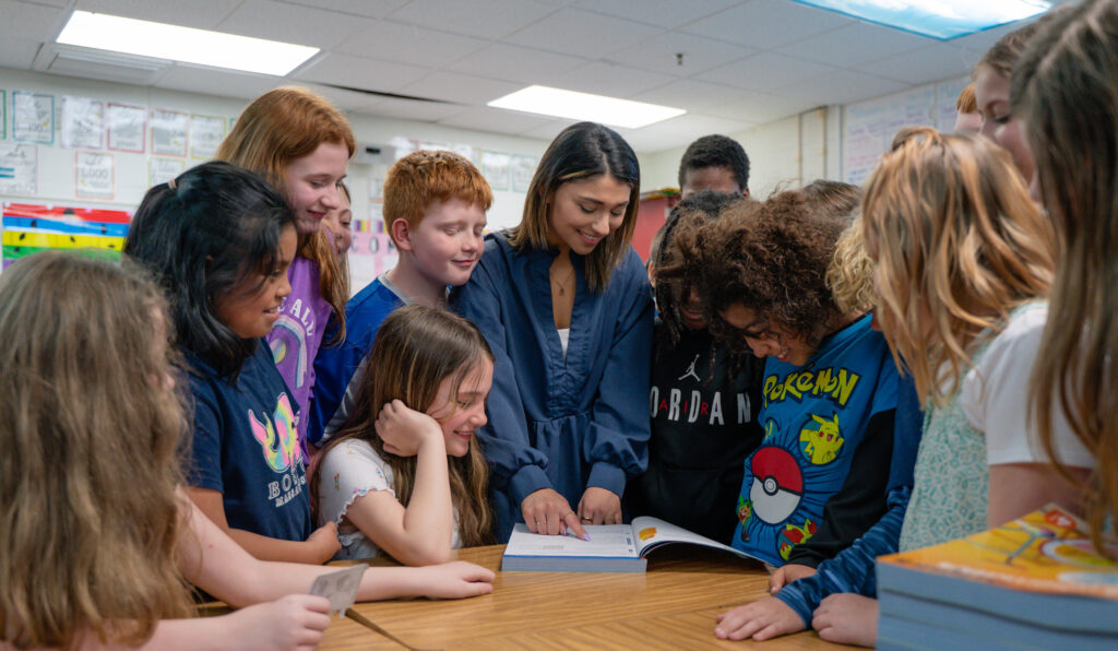 a teacher surrounded by students