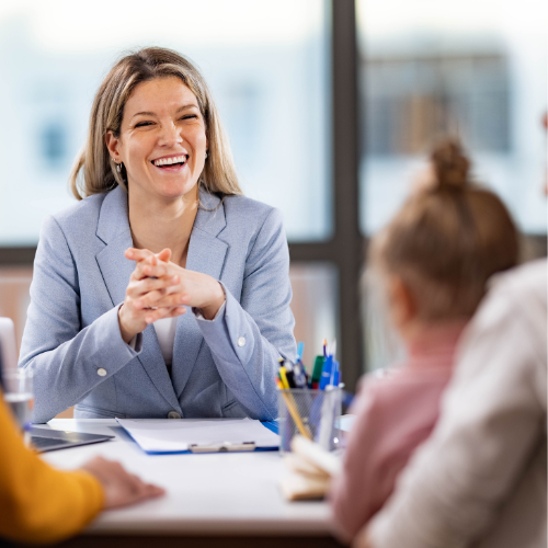 Photo of a principal meeting with parents at a school.