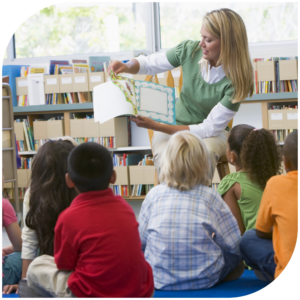 Photo of teacher reading a book to her students.